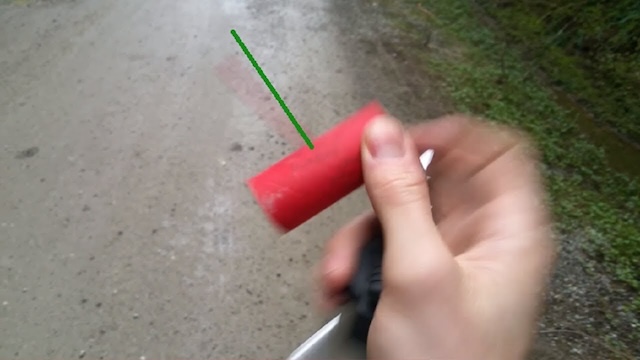 Holding an M-80 firecracker with the fuse ready to go—this tiny stick packed a mighty boom. Not for the faint of heart! 