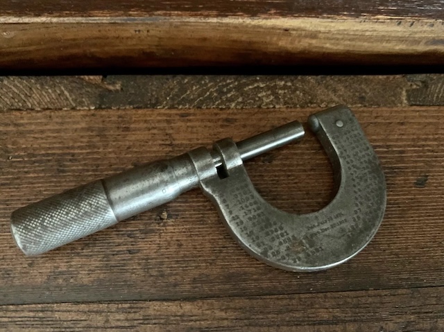 This micrometer, with its well-worn handle, has likely measured countless metal parts over the years, making it a must-have for machinists and engineers