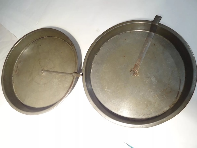 Two vintage slider cake pans side by side, illustrating the simple but effective design that made them a household staple in the mid-20th century