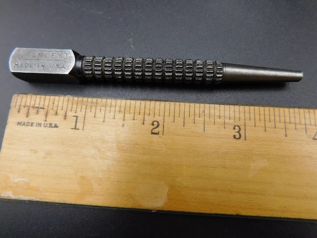 The Vintage Stanley punch tool, crafted in the USA, showcasing its precise measurements with a ruler for scale