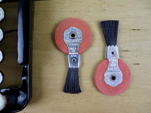 Two well-worn vintage typewriter wheel and brush erasers, used to delicately erase mistakes from documents without ruining the paper