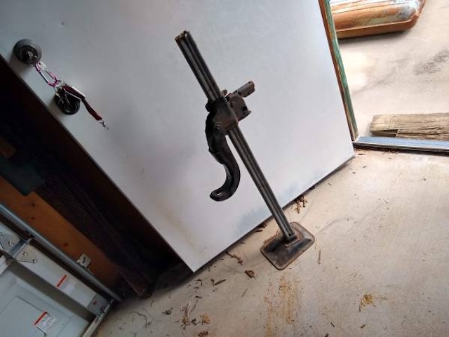 Standing tall in the garage, this bumper jack tells stories of countless flat tires changed by hand