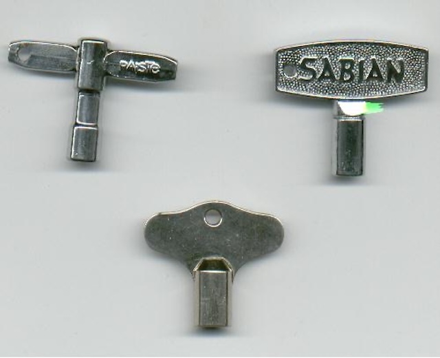 A collection of drum keys from different eras, including models by Sabian and Yamaha, each designed to maintain drumhead tension