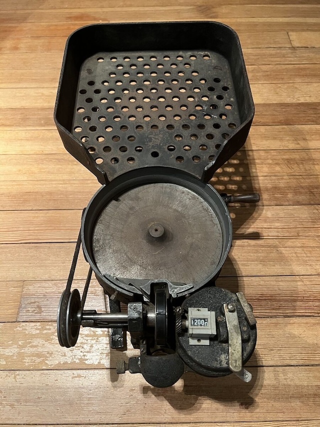 The perforated tray above was designed to hold loose coins before they were funneled into the machine for counting, ensuring an organized process