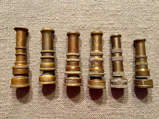 A collection of vintage GEM brass water nozzles showcasing various styles, each telling a different part of their historical journey