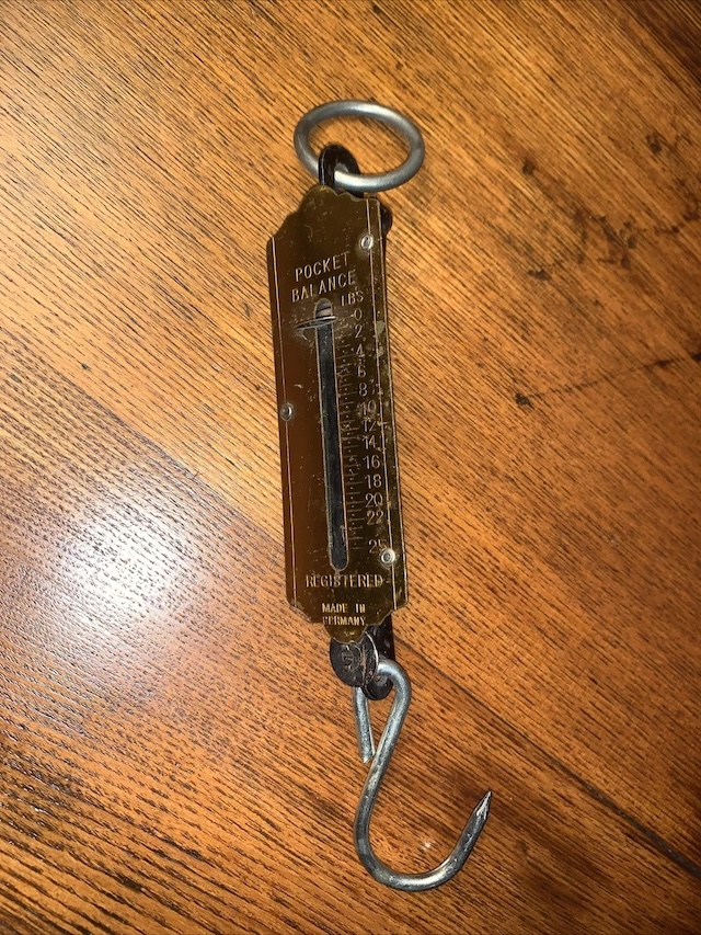 A closer look at the "Vintage Pocket Balance Hanging Scale," displaying its distinct engraving and measuring increments, a tool that made trading simple and accurate