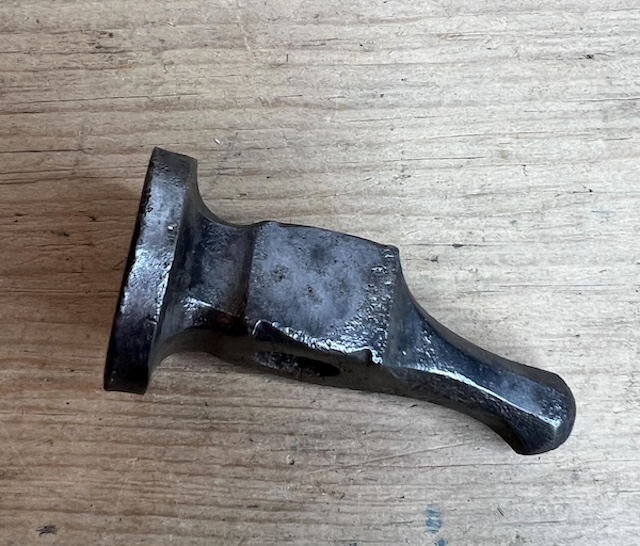 Smoothly worn from use, this vintage hammer head has shaped countless intricate metal designs over the years