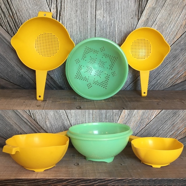 A nostalgic collection of vintage kitchen strainers in bright colors—tools that once played an essential role in daily cooking routines