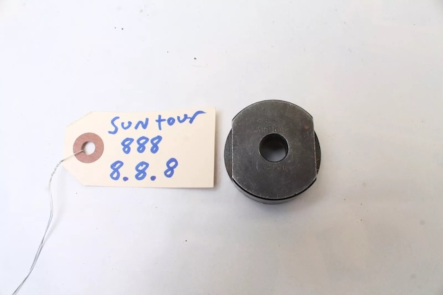 The flat view of the vintage Suntour 888 bicycle freewheel cassette hub removal tool, showing the other side of the piece, which fits into the cassette hub for easy removal