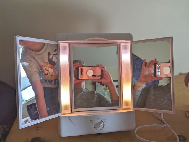 A classic Conair lighted mirror in action, helping generations perfect their beauty routines