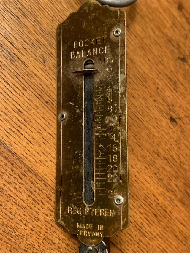 A closer look at the "Vintage Pocket Balance Hanging Scale," displaying its distinct engraving and measuring increments, a tool that made trading simple and accurate