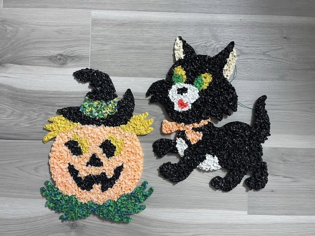 A cheerful pumpkin with a witch hat and a playful black cat make these melted plastic popcorn decorations a must-have for vintage Halloween decor enthusiasts