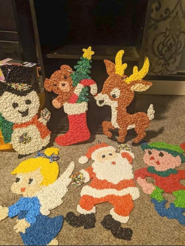 A joyful holiday scene with classic Christmas characters, including a reindeer, Santa Claus, and a Christmas stocking, all crafted from melted plastic popcorn decorations