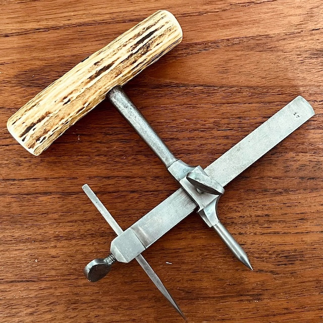 A full view of the antique gasket cutter, showing its robust design. Tools like this were essential for anyone working with gaskets and seals