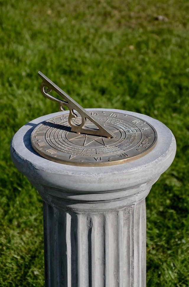 An elegant sundial perched on a stone pillar, blending classical design with ancient technology, once guiding civilizations through the passage of time