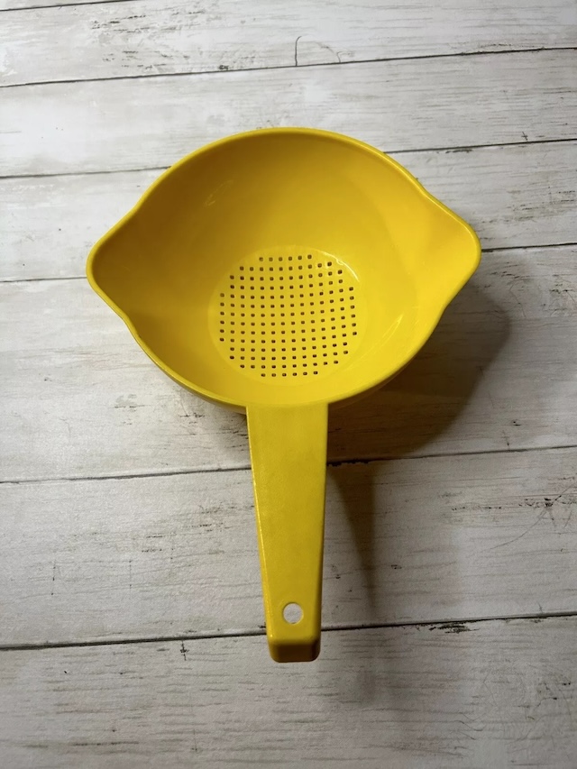 Simple and sturdy, this vintage yellow plastic strainer was used for draining pasta, washing vegetables, and more