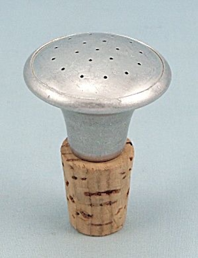 Simple in design but highly functional, this vintage sprinkler bottle top helped ensure clothes were ironed without creases