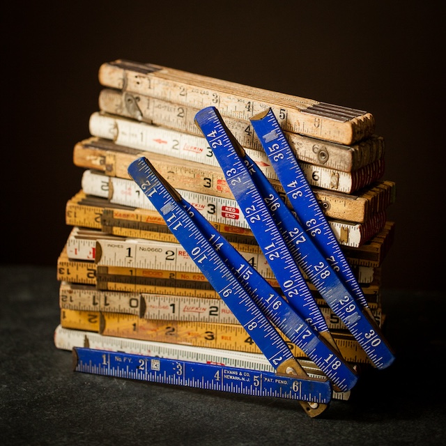 These blue folding rulers stand out among the wooden ones, proving that even the most basic tools could come with a touch of style