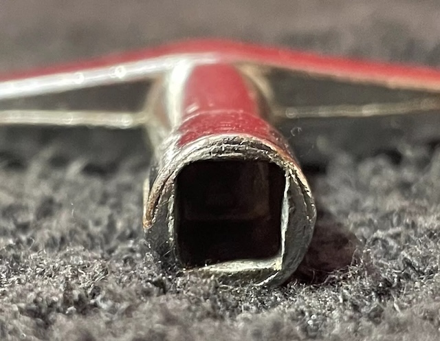 A close-up of a well-used drum key, showing the wear and tear of a seasoned drummer’s essential tool