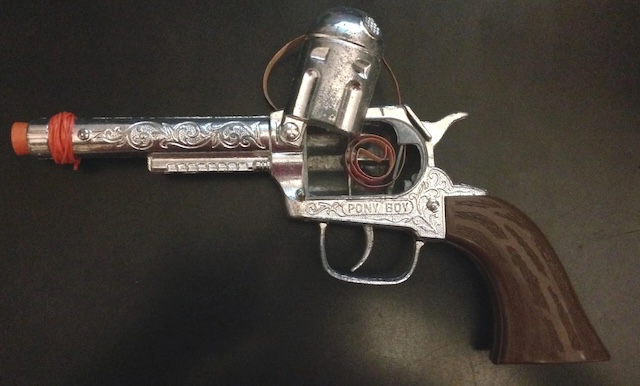 The iconic Pony Boy vintage cap gun, beautifully designed with intricate engravings, still stands as a nostalgic symbol for generations of children