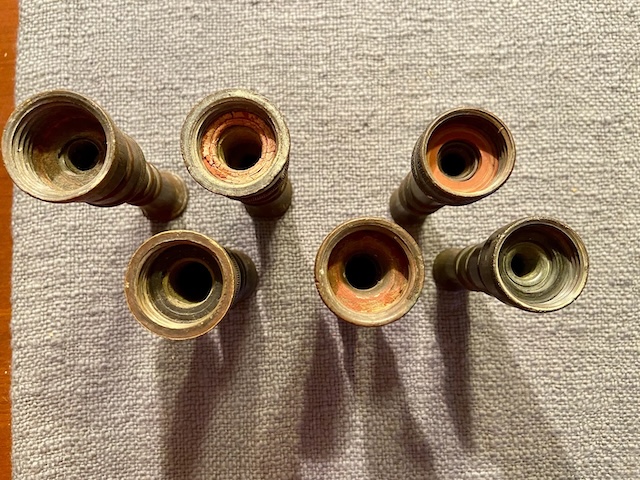 The inside view of several vintage GEM brass water nozzles, showing wear from decades of use yet maintaining their structural integrity