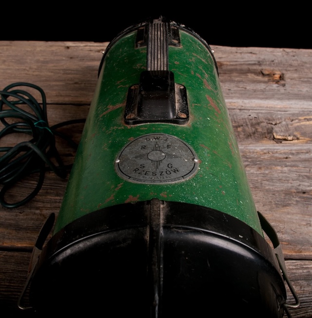 The intricate detailing on this vintage vacuum cleaner shows the meticulous craftsmanship that was a hallmark of early household appliances