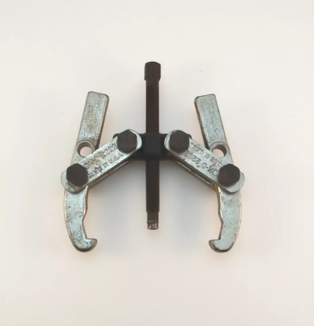 This two-jaw gear puller was often used to safely remove gears without causing damage, a critical tool for working on engines and machinery