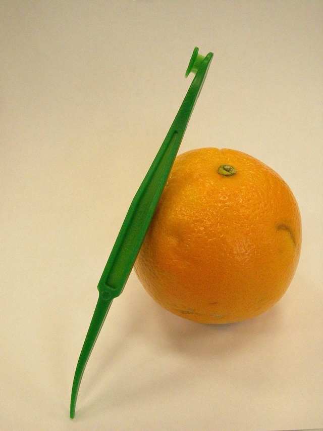 The citrus peeler at work! It easily cuts through the peel, making orange peeling a breeze