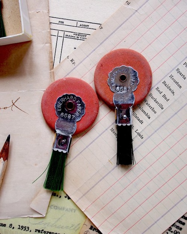 Vintage erasers neatly displayed amidst old paperwork—a throwback to an era where making a typo meant reaching for one of these trusty tools