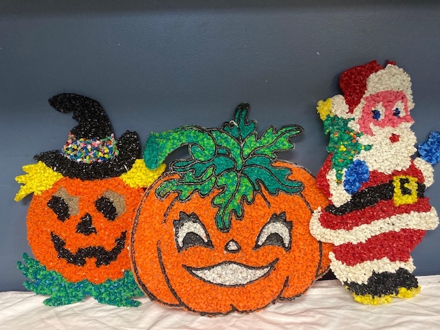 Halloween meets Christmas with these vintage melted plastic popcorn decorations, featuring a pumpkin, a friendly Santa, and a mischievous witch