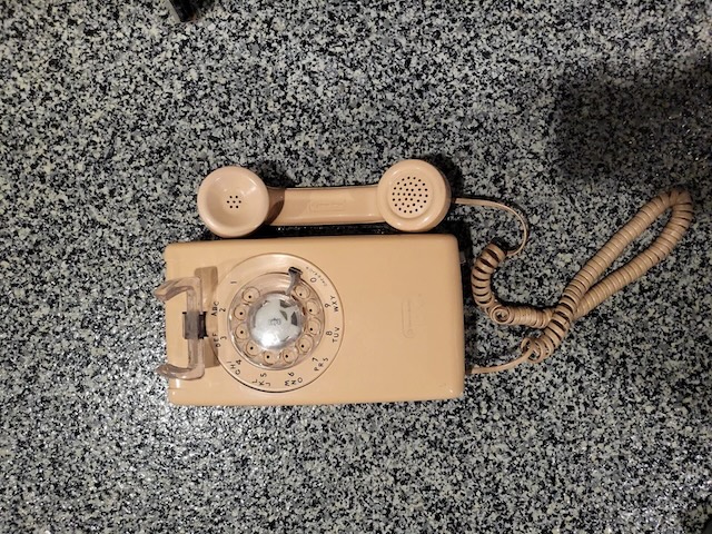 Another view of the timeless rotary phone 554, showing its compact design and durability, qualities that made it a household essential for many years