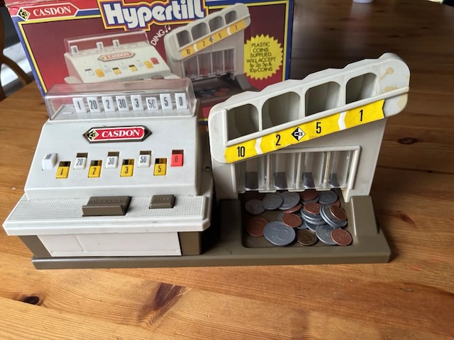 The Casdon 'Hypertill,' a more advanced model featuring plastic coins, offering kids a more realistic shopkeeping experience