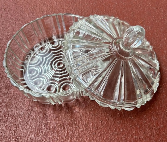 This timeless glass candy dish sits ready to hold its sweets once again, evoking memories of childhood treats and crystal-clear decor