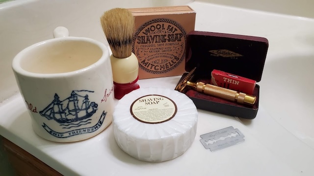 This set, with its shaving soap and gold razor, shows the luxurious simplicity of a vintage shaving set, cherished by many men in the past