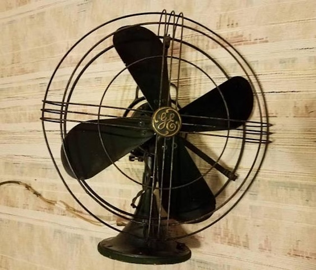 This vintage GE fan is mounted on a wall, adding both functionality and charm to any space