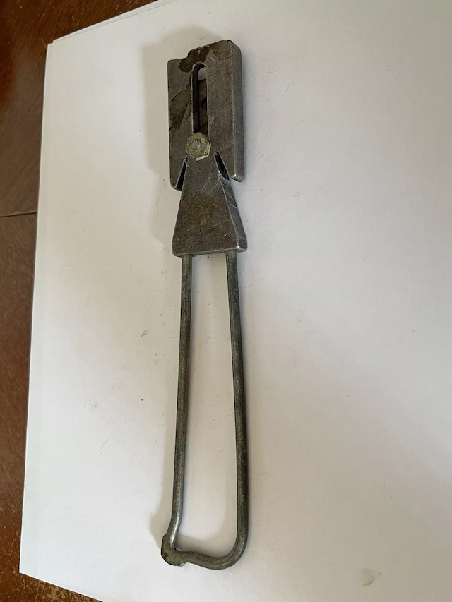 This vintage tool, simple in construction, reflects an era where manual sharpening tools like this were indispensable in every household