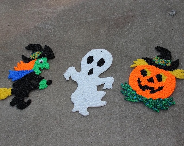 These playful Halloween characters—witch, ghost, and pumpkin—are brought to life with the vibrant colors and textures of melted plastic popcorn decorations