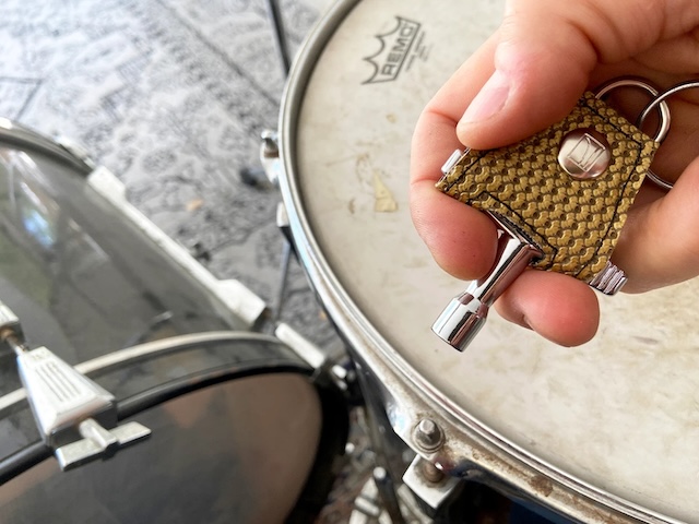 A drum key attached to a keychain for convenience, always within reach during practice or live performances