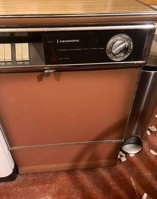 Another model of a Kenmore portable dishwasher, with its distinctive wood accents and retro design, this appliance still stands as a symbol of functionality and durability from the past