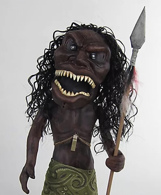 A detailed look at the face of the doll, with its exaggerated features, sharp teeth, and iconic wild hair, making it one of the most terrifying horror props of its time