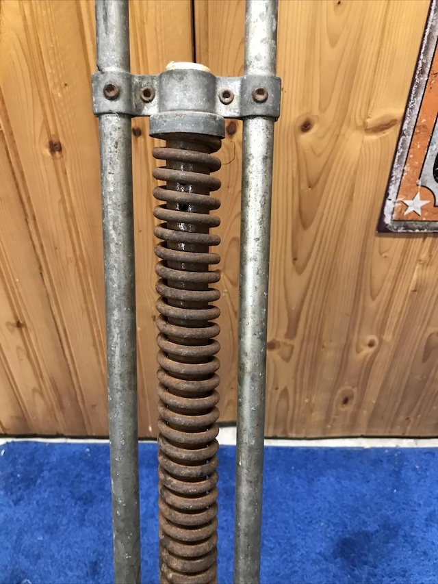 With a warm, wooden backdrop, the pogo stick stands in front of a dad's garage, bringing back memories of backyard fun and simpler times