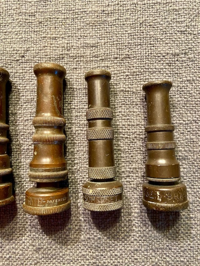 The detailed craftsmanship on the engraved text, including the brand and patents, demonstrates the longevity and quality of these vintage GEM brass water nozzles