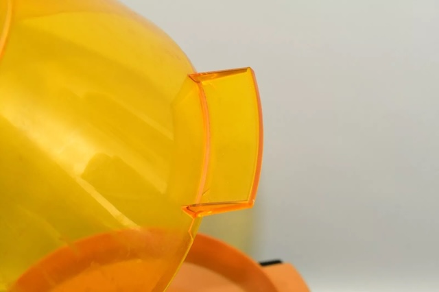 The translucent orange lid, designed for even butter distribution and a perfect view of the popping corn