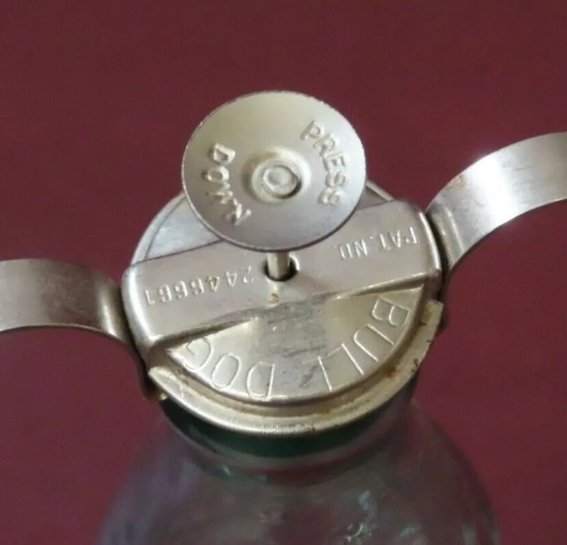 A top-down view of the stopper, with the bold "BULLDOG" branding engraved, adding authenticity to this iconic piece of soda history