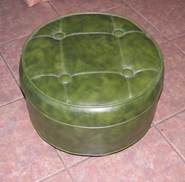 This vintage green ottoman pouffe once served as both a comfy footrest and secret storage