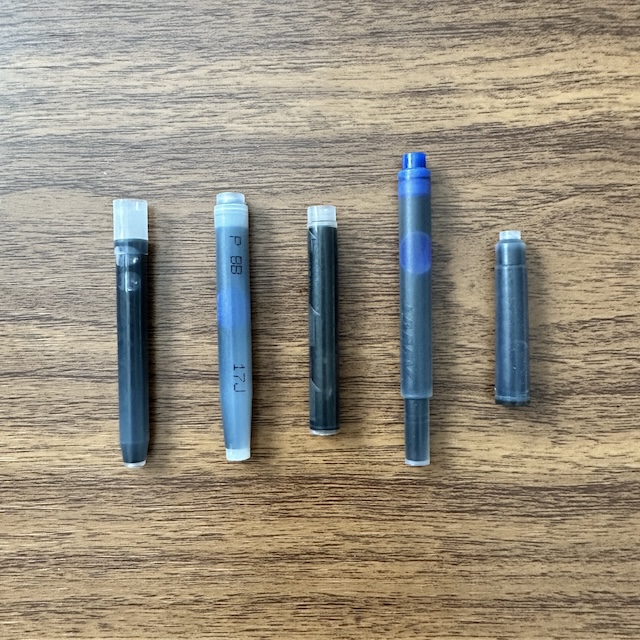 Different shapes and sizes of fountain pen ink cartridges, showcasing their evolution over time