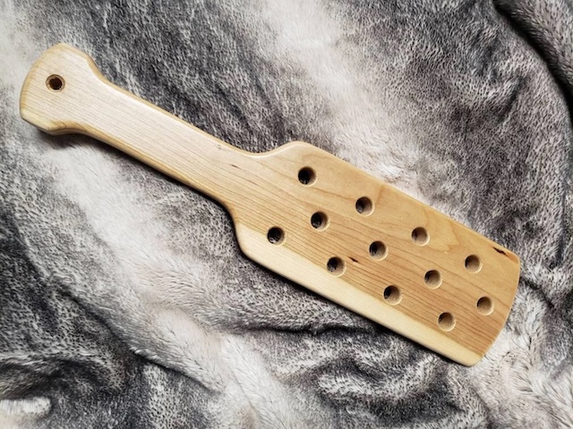 A classic example of the past—this vintage wooden paddle carries the weight of history and tradition