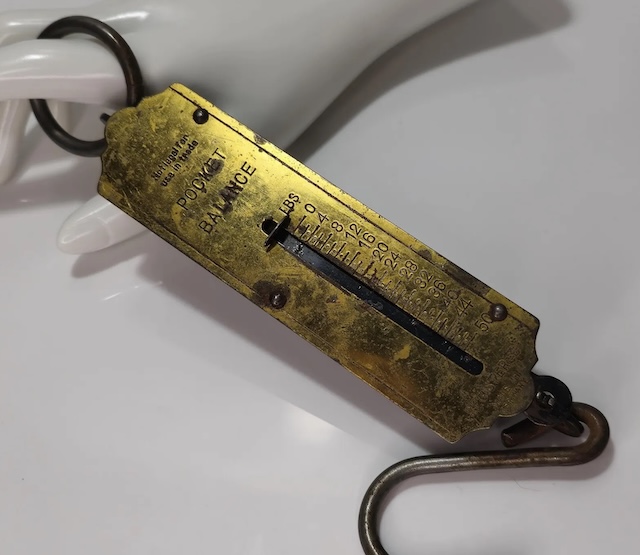 An iconic tool for merchants and travelers alike, this "Vintage Pocket Balance Hanging Scale" represents the perfect marriage of portability and function, often carried to markets worldwide