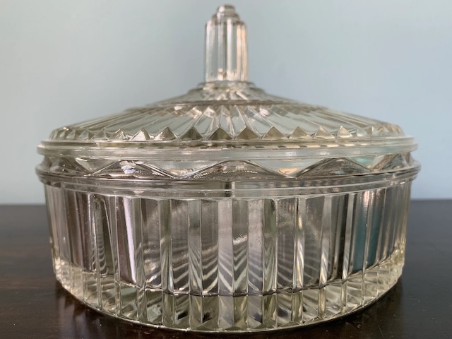 A closer look at the ribbed glasswork and delicate details of this vintage candy dish, bringing a touch of history into any modern home