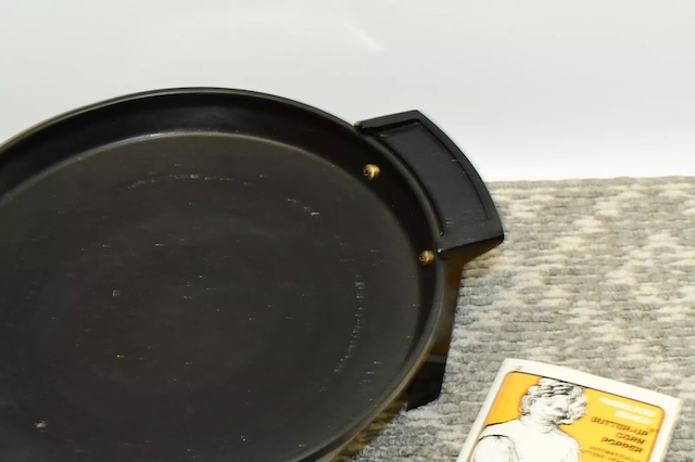 The black heating plate where kernels would pop to golden perfection, a symbol of classic craftsmanship